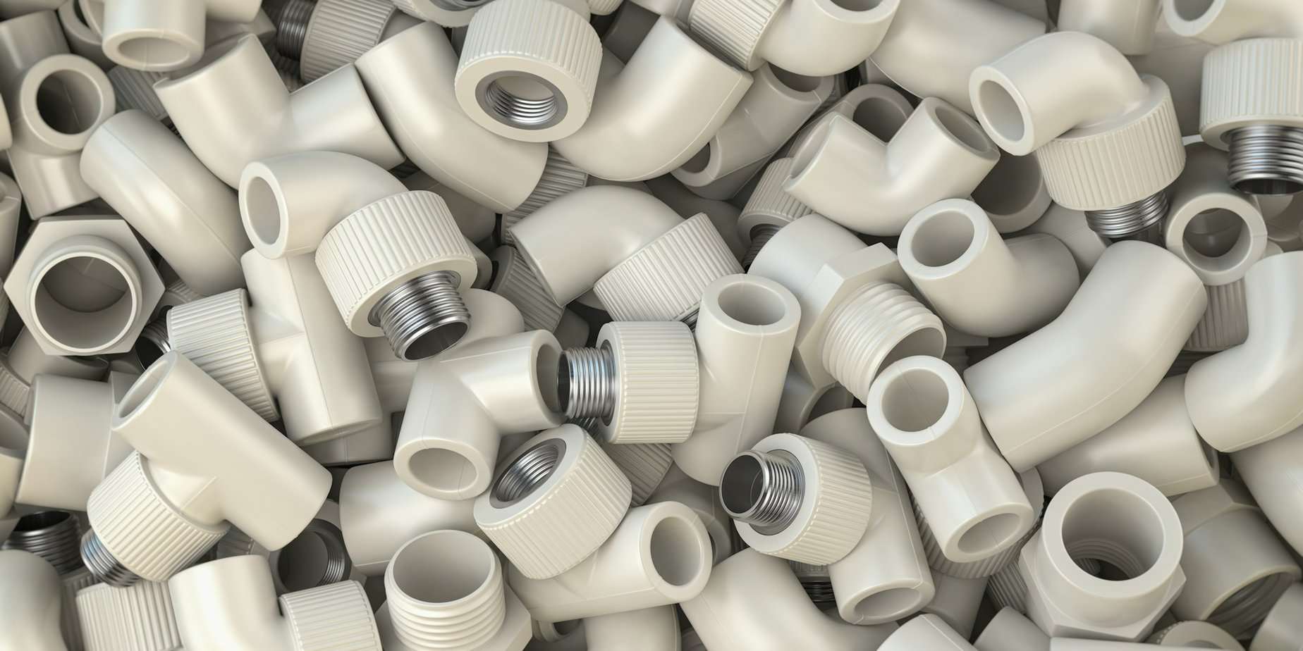 Various fittings of pvc plastic pipes and tubes in heap. Plumbing ackground.