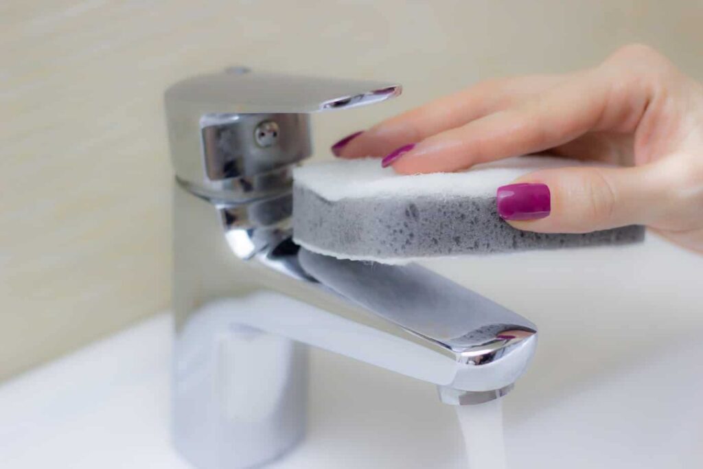 woman-cleaning-tap-with-sponge.jpg